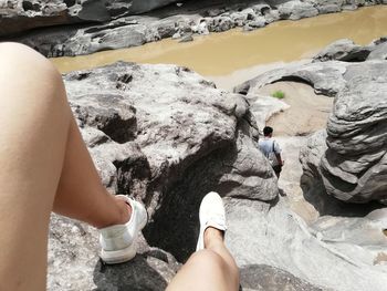 Low section of women standing on rock