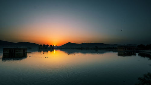 Scenic view of lake against sky during sunset