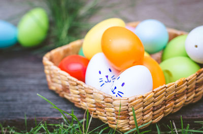 Close-up of multi colored eggs in basket