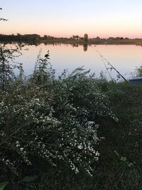 Scenic view of lake against sky at sunset