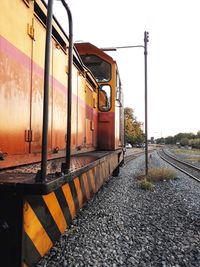 Train at railroad station platform against sky