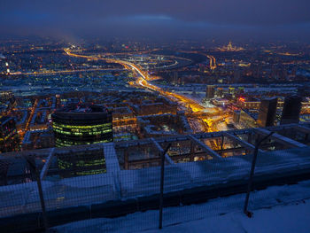 High angle view of city lit up at night
