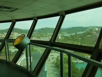 Scenic view of city seen through glass window