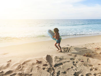 Full length of man on beach against sky