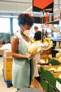 Woman holding ice cream at market