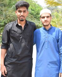 Portrait of friends in traditional clothing standing on road against trees