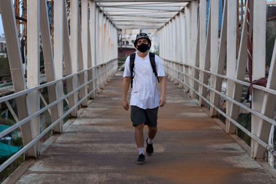 Full length of woman walking on footbridge