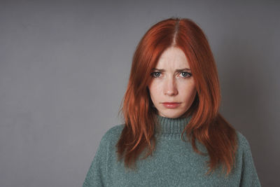 Portrait of young woman against white background