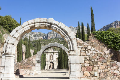 Archway of historic building against clear blue sky