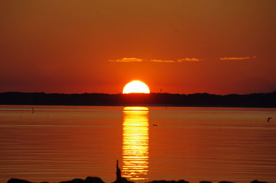 Scenic view of sea against romantic sky at sunset