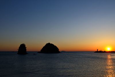 Scenic view of sea against clear sky during sunset