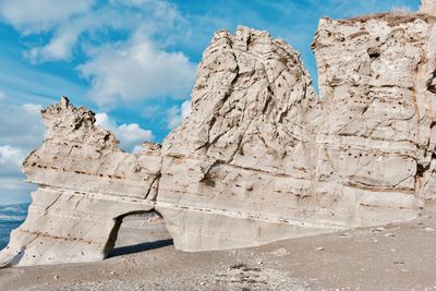 Low angle view of rock formation against sky