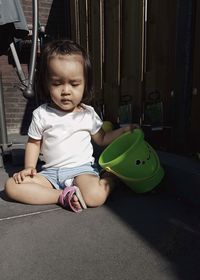 Cute baby girl sitting with toy