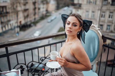 Portrait of woman standing in city