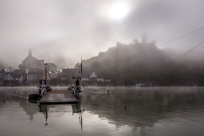 View of boats in lake against sky