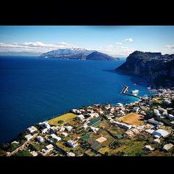 Aerial view of sea with cityscape in background