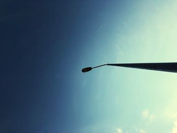 Low angle view of street light against blue sky