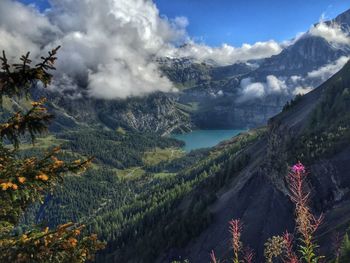 Scenic view of mountains against cloudy sky