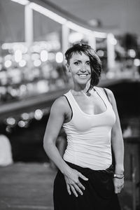 Portrait of smiling young woman standing outdoors