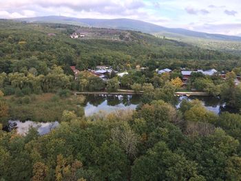 Scenic view of river against cloudy sky