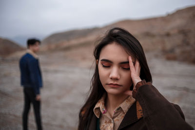 Portrait of a beautiful young woman lying on land