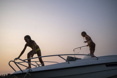 Children standing on boat