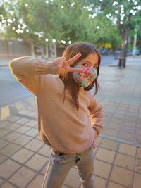 Full length of girl standing on footpath