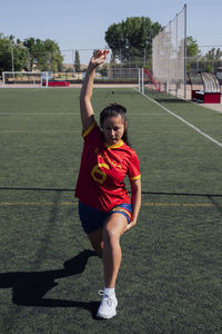 Player doing warm up exercise on sports field