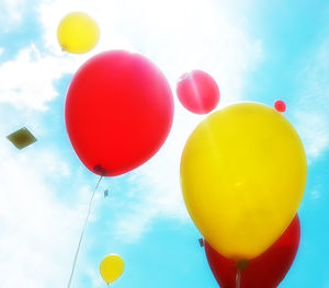 Low angle view of balloons against sky