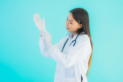 Woman looking at view of blue background