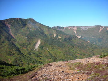 Scenic view of mountains against clear blue sky