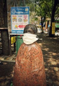 Rear view of woman standing on street