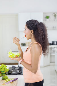 Side view of woman preparing food at home