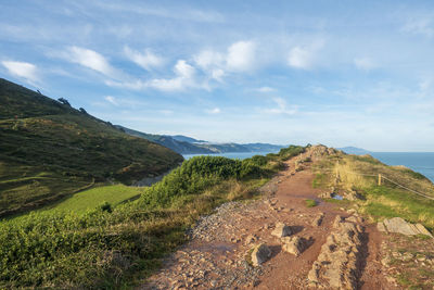 Scenic view of sea and mountains against sky