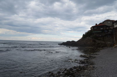 Scenic view of sea against cloudy sky