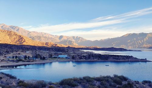 Scenic view of lake and mountains against sky