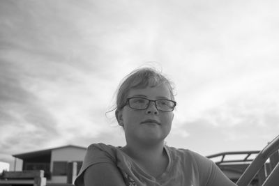 Close-up of girl against sky