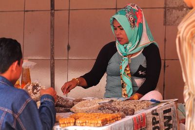 Woman selling food item at market