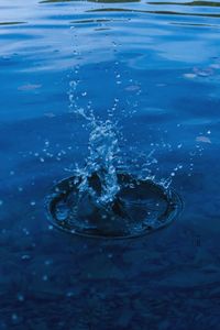 High angle view of drop falling on water