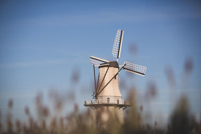 Low angle view of windmill against clear sky