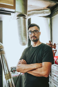 Portrait of a man standing against wall