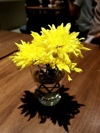 Close-up of yellow flower in vase on table