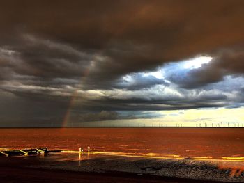 Scenic view of sea against storm clouds