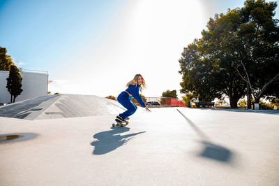 Portrait of smiling woman skating at park