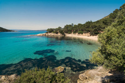 Scenic view of sea against clear blue sky