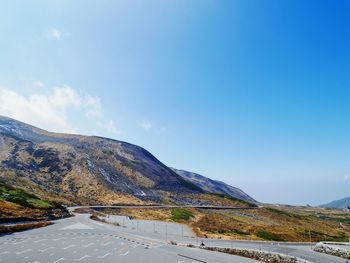 Scenic view of mountains against blue sky