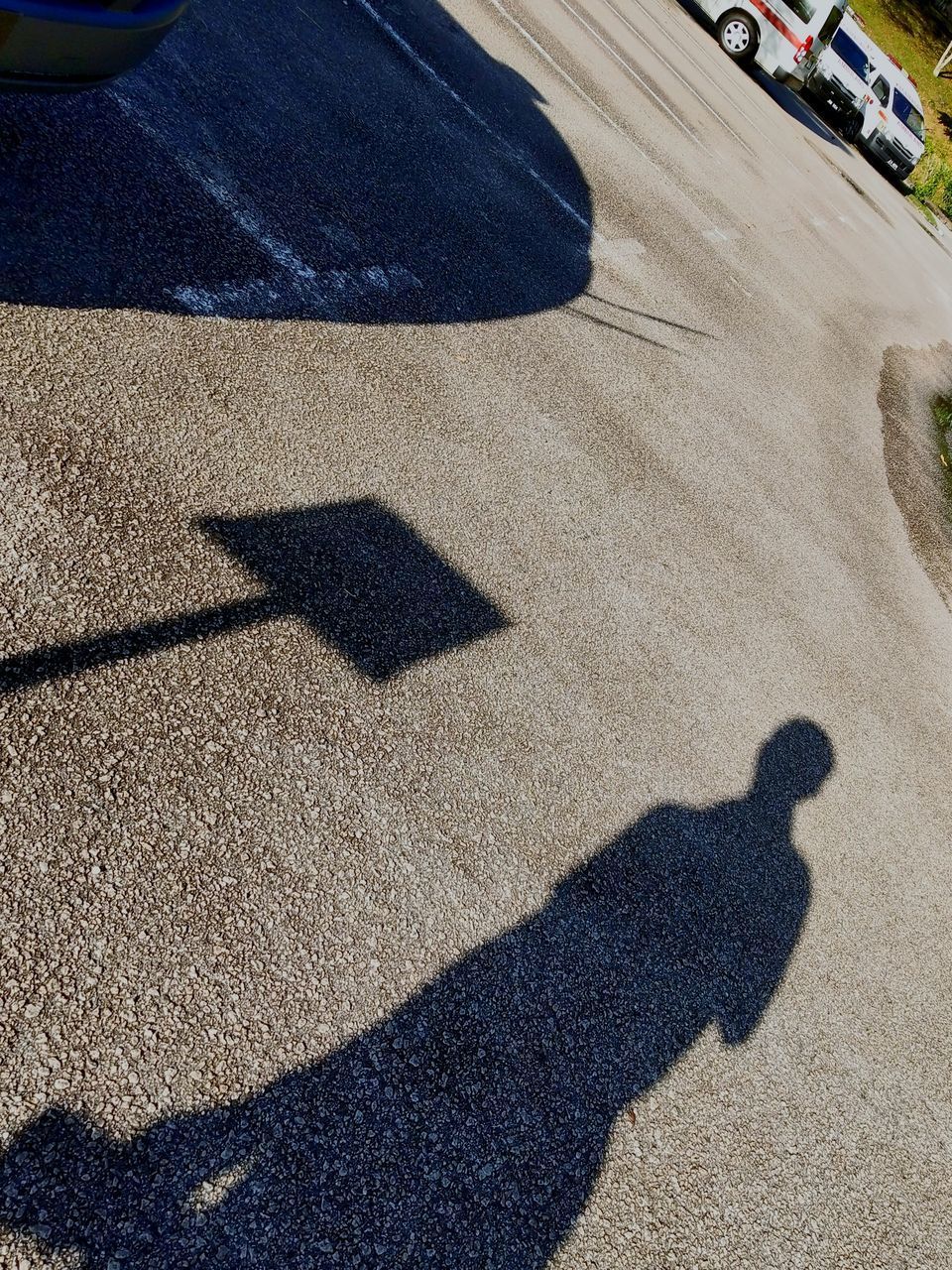 HIGH ANGLE VIEW OF SHADOW ON STREET