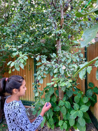 Woman standing by plants