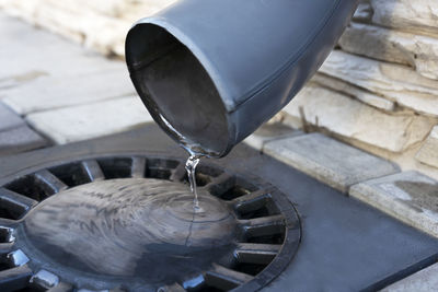 Water from melted snow flowing from plastic gutter into drainage system.