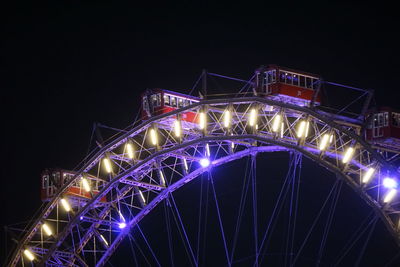 Low angle view of illuminated building against sky at night